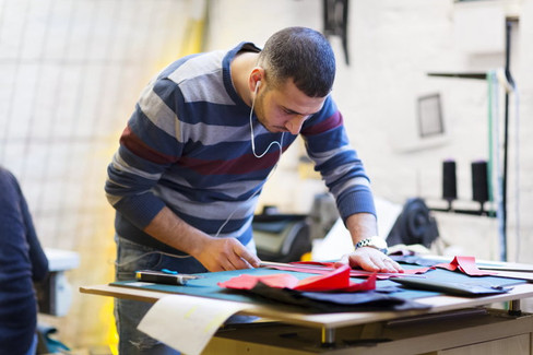 Khaldoun the tailer working on a bag